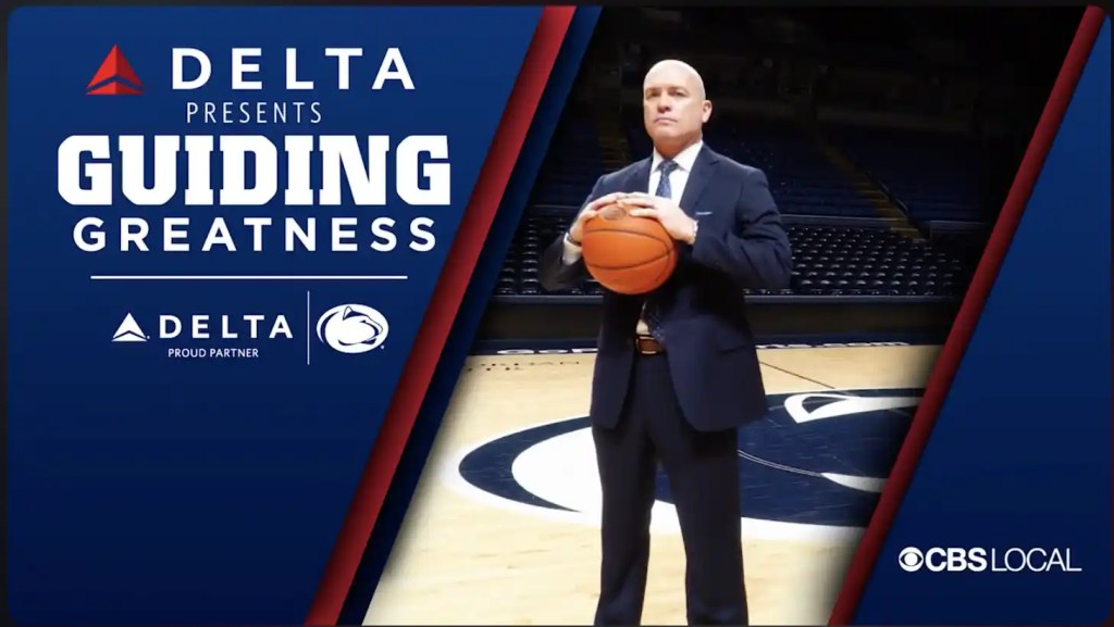 Coach of Penn State Holding a Basketball.  Text of Delta Presents Guiding Greatness